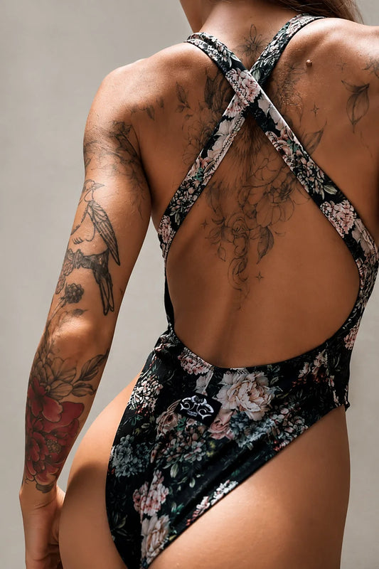 Back view of Benita Bodysuit Fiori featuring crossed straps, open-back design and floral print for pole dance, swimwear and fitness.