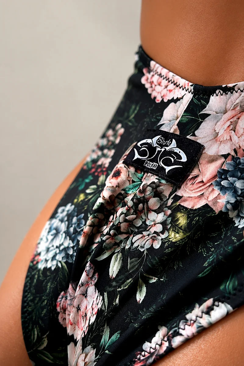 Close-up detail of Benita Bodysuit Fiori featuring a romantic floral print, ruched front design and premium stretch fabric by Sharkpolewear.